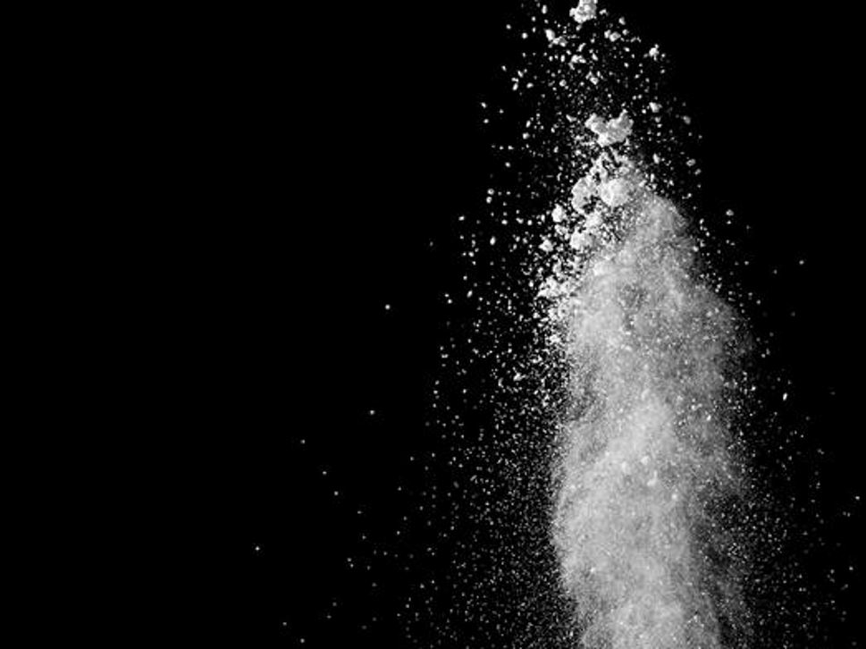 White powder splatter on black background